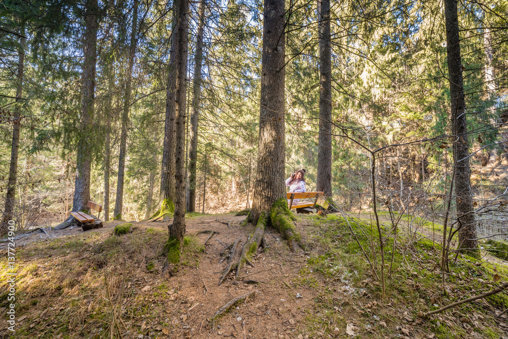 woman talking on mobile phone in forest woman talking on mobile phone in forest