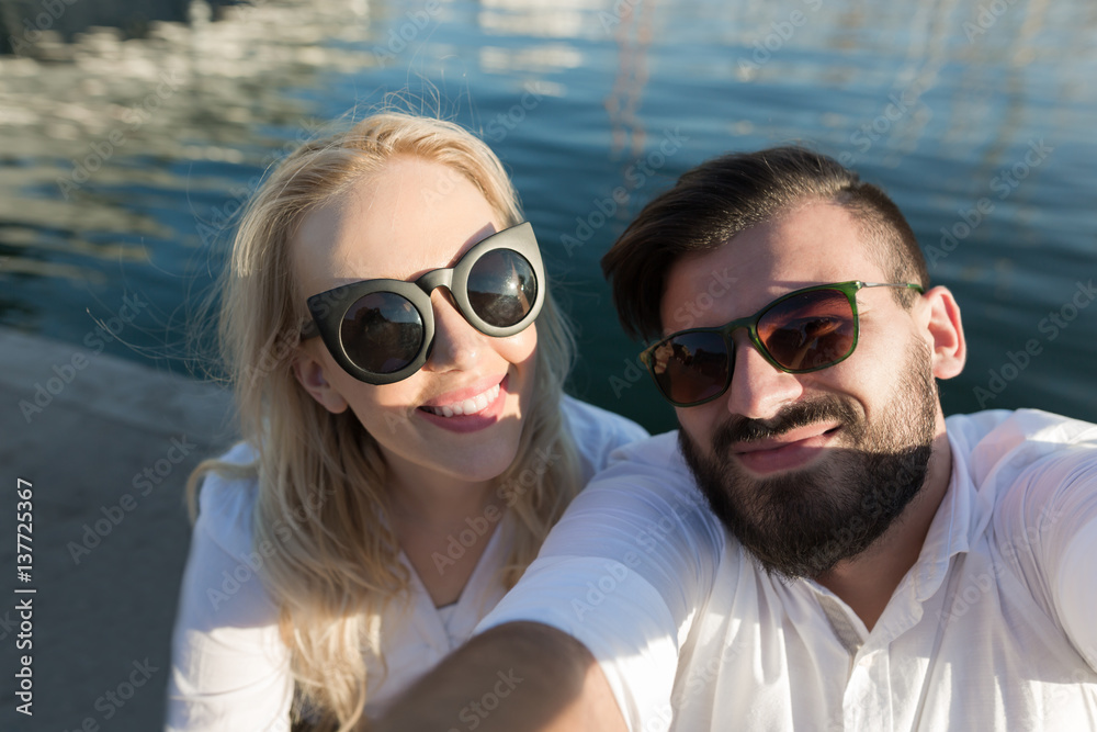 Capturing bright moments. Joyful young loving couple making selfie on camera while standing outdoors Capturing bright moments. Joyful young loving couple making selfie on camera while standing outdoors