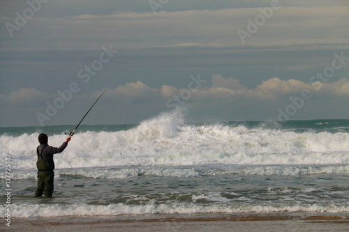 Fisherman among the waves