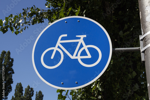 Blue sign of a bicycle track in Munich, Germany, 2015