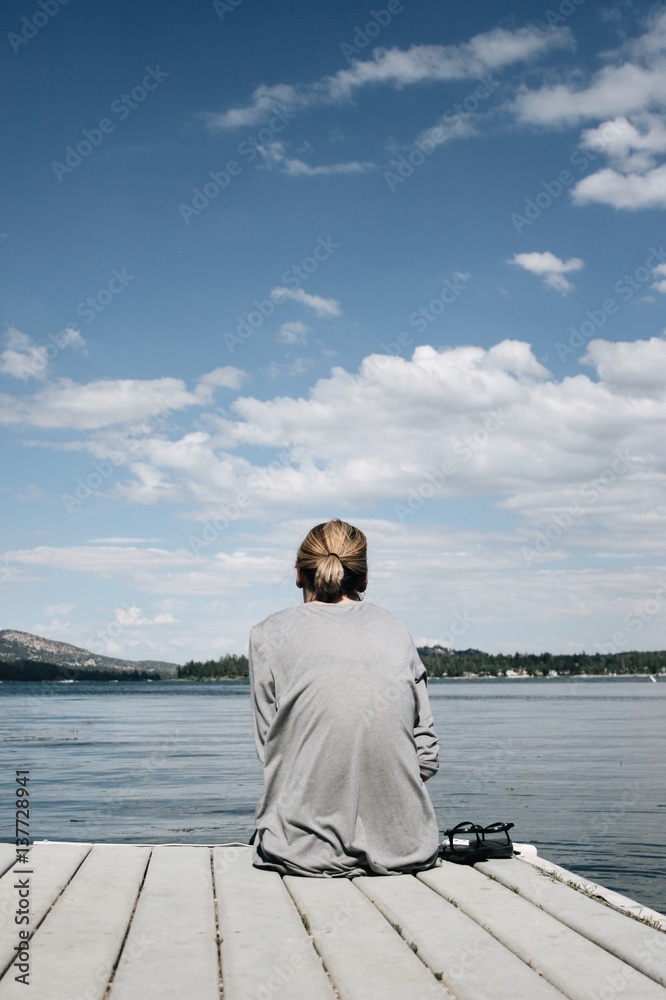 Young woman looking at a view of a lake