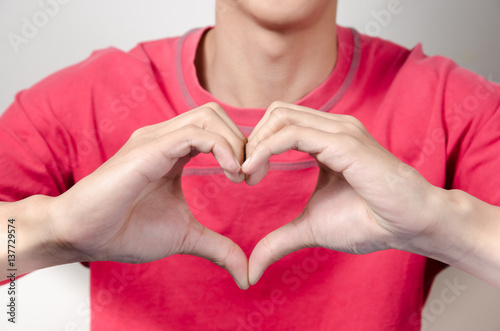 Asian young man make heart hand