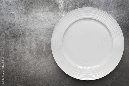 Empty White Plate over Gray Slate Top View