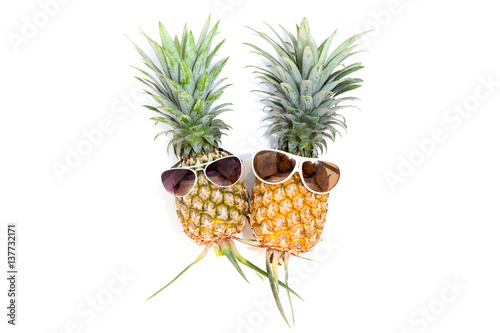  pineapple with sunglasses on white background.