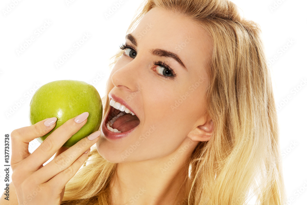 Young happy woman eating fresh green apple Young happy woman eating fresh green apple