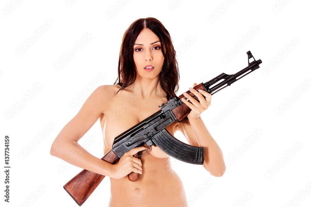 Sexy nude brunette girl model with weapon.