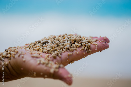 man palm holding pebble  and sand