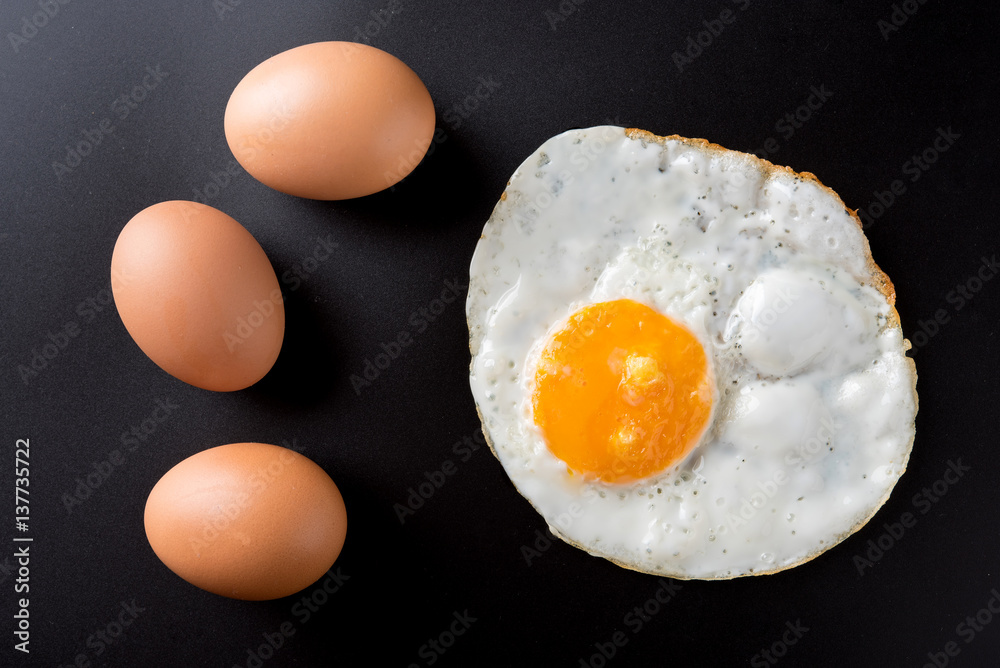 top view of fried eggs on black background, egg top view of fried eggs on black background, egg