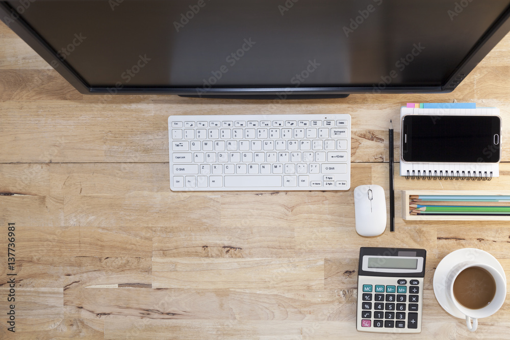 Top view with wood table, computer with keyboard,paper note,pencil,airplane model,flower,smartphone and coffee cup. Top view with wood table, computer with keyboard,paper note,pencil,airplane model,flower,smartphone and coffee cup.