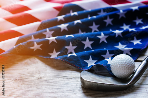 Golf ball with flag of USA on wood table