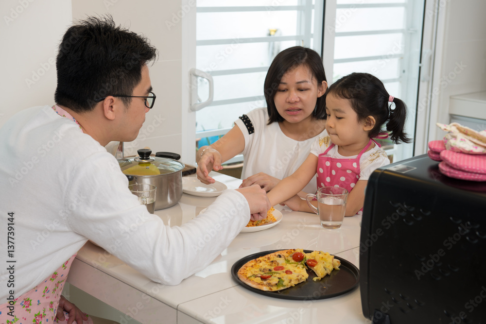 asian family enjoying and cooking pizza asian family enjoying and cooking pizza