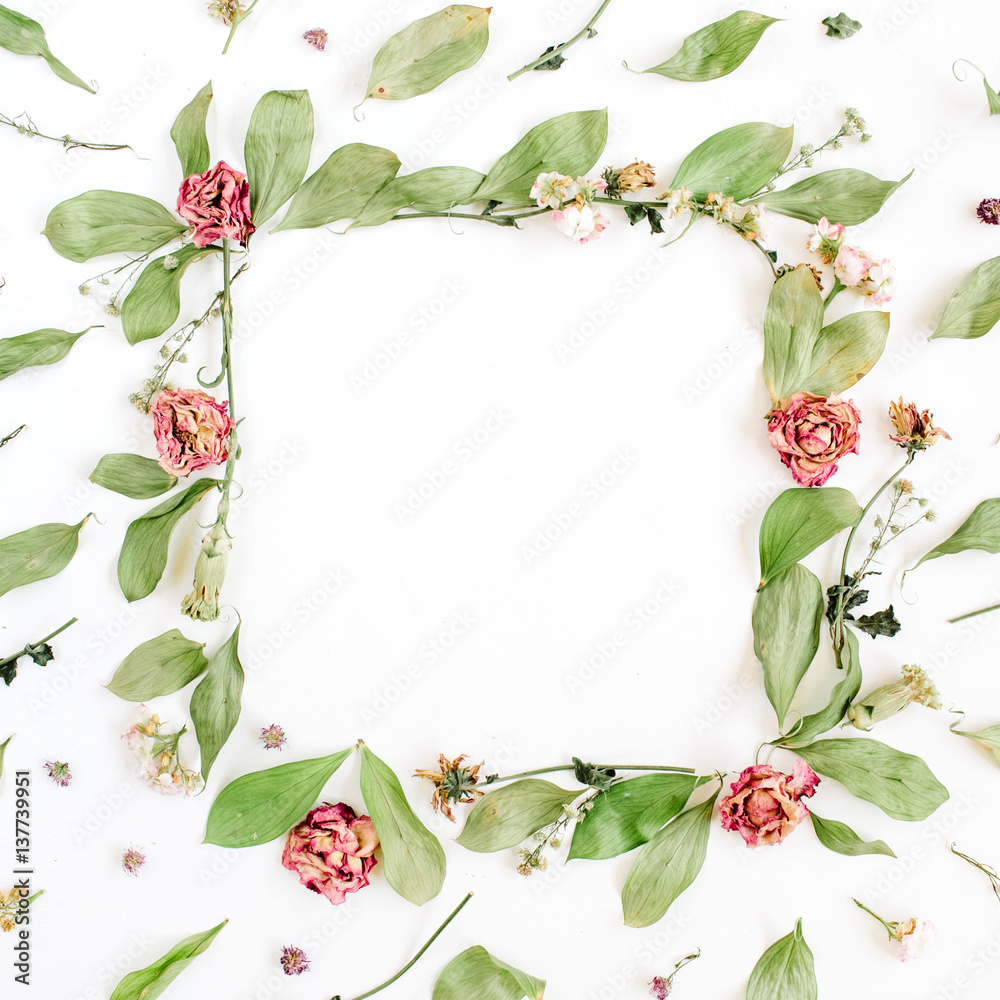 Fototapeta premium Round frame wreath pattern with roses, pink flower buds, branches and leaves on white background. Flat lay, top view. Flowers pattern