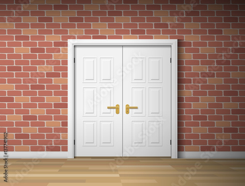 room interior with white door and brick wall