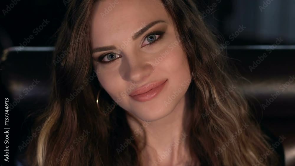 Portrait of a gorgeous girl which is looking at the camera, slow motion.