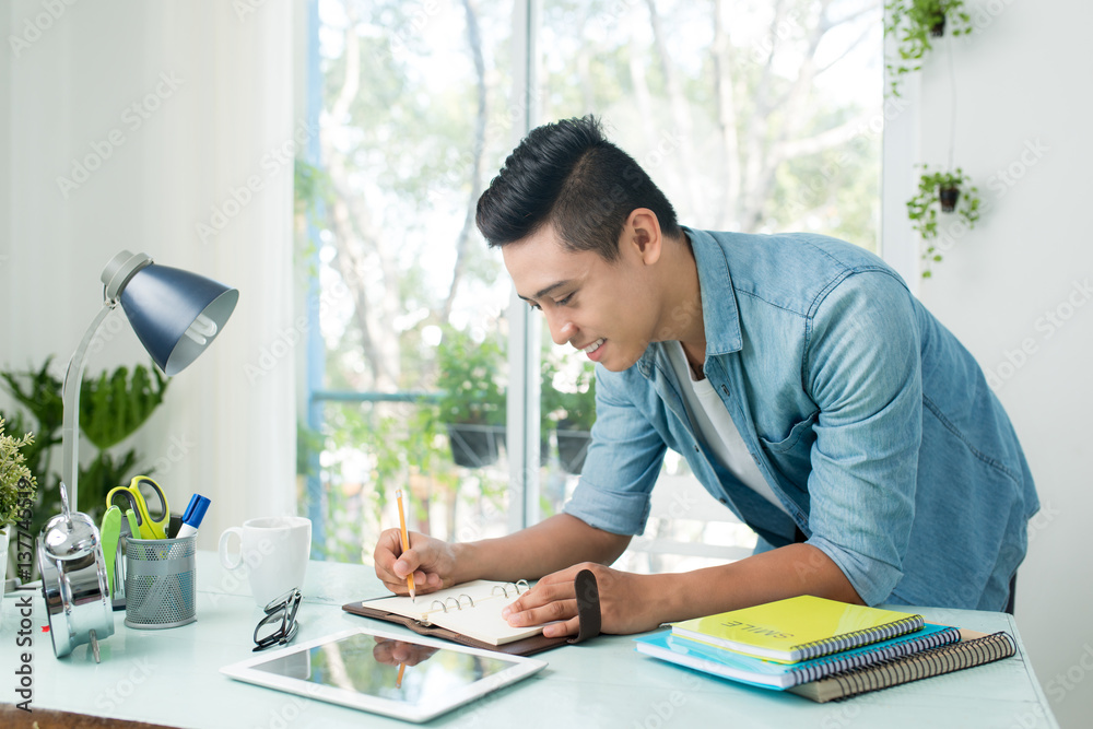 Student doing homework and preparing exam at home. Student doing homework and preparing exam at home.