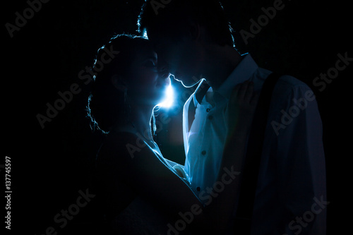 Canvas Print Loving couple backlit with a blue light