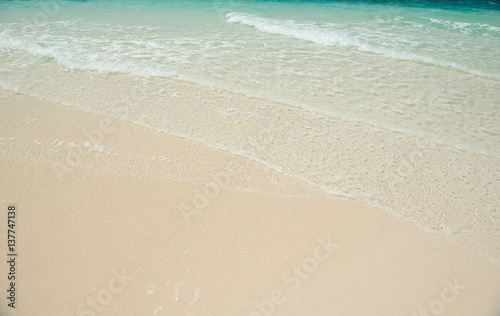 sandy beach and clear transparent sea wave