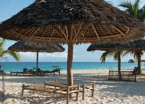 beautiful clean Zanzibar beach with umbrellas and benches