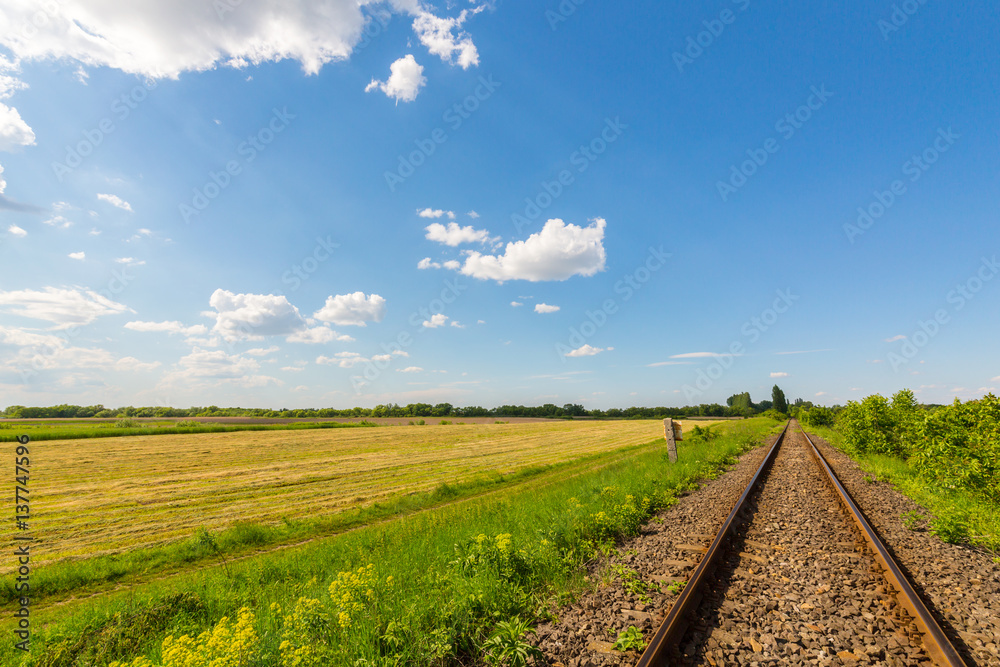 Obraz premium Scenic railroad in remote rural area in spring, in Eastern Europe