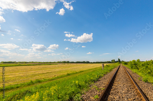 Fototapeta Naklejka Na Ścianę i Meble -  Scenic railroad in remote rural area in spring, in Eastern Europe