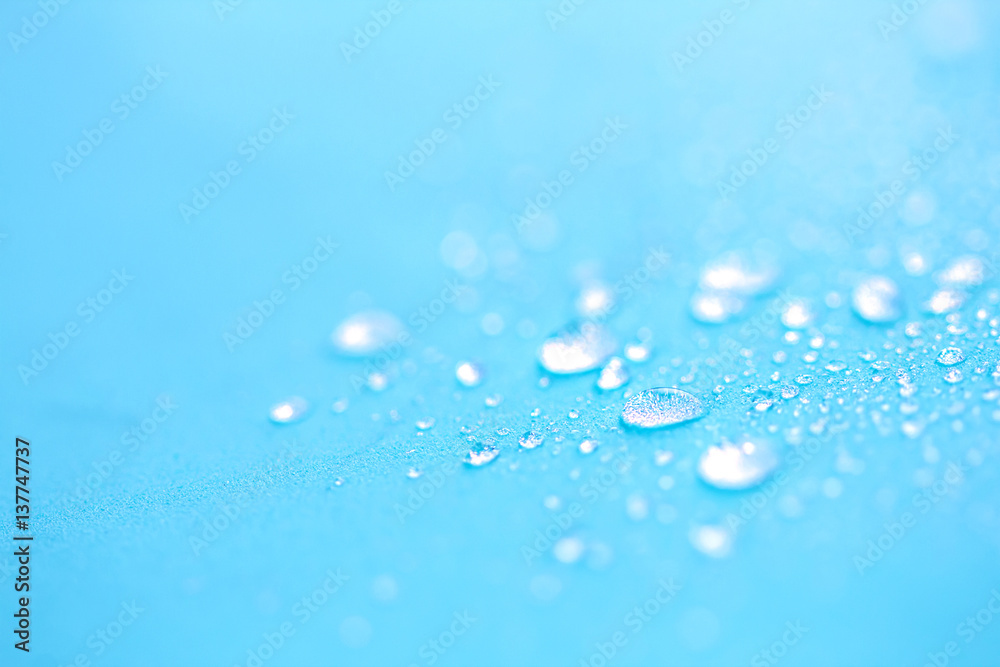 Close up rain water drops on blue sponge surface as abstract background Close up rain water drops on blue sponge surface as abstract background
