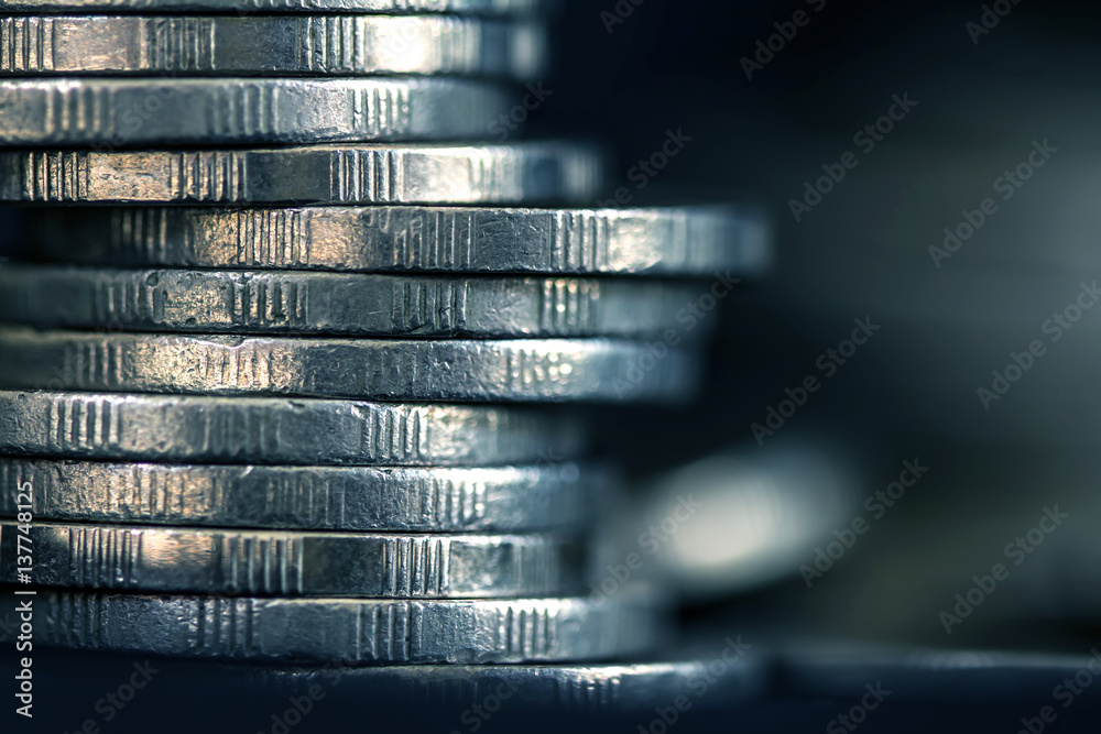 Close up silver money coin stacking on dark background Close up silver money coin stacking on dark background