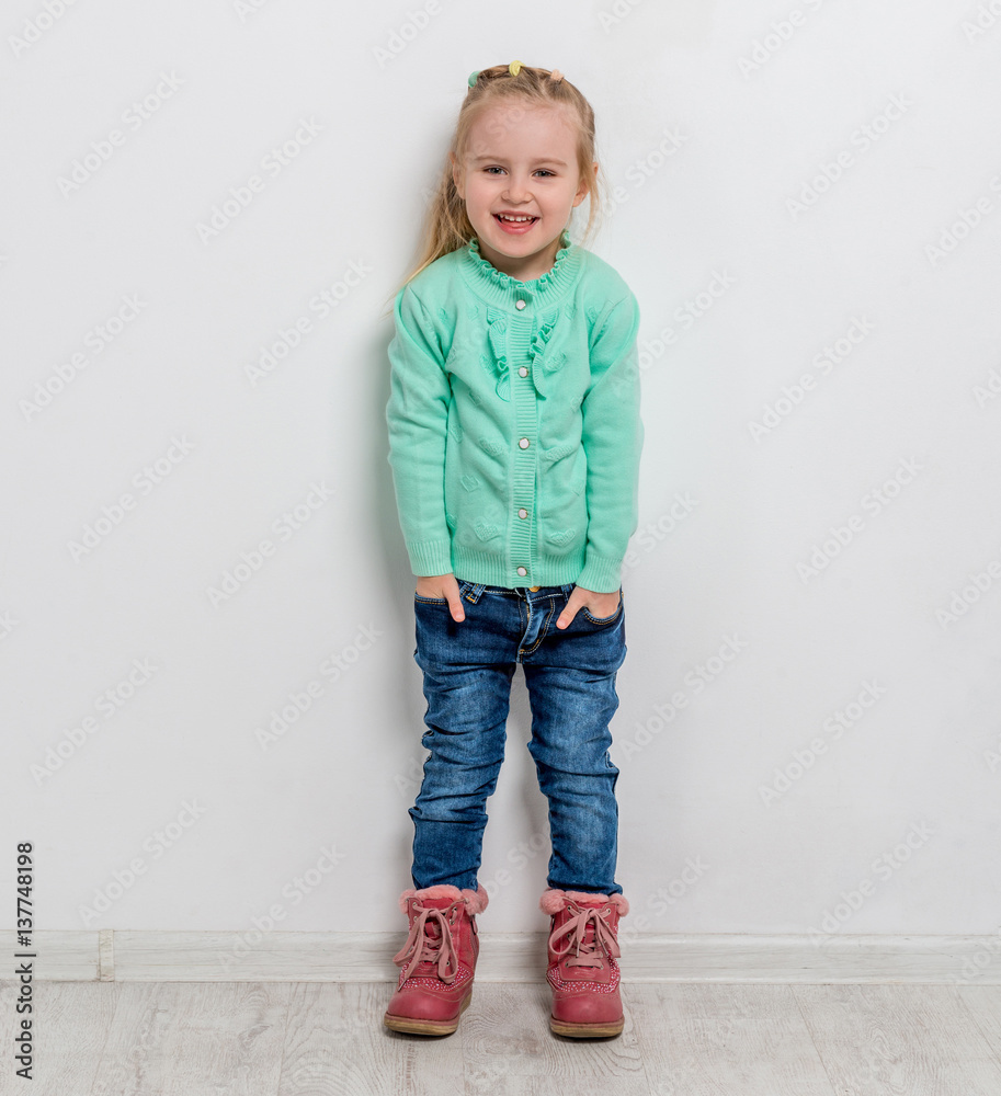 beautiful little girl with her hands in pockets beautiful little girl with her hands in pockets