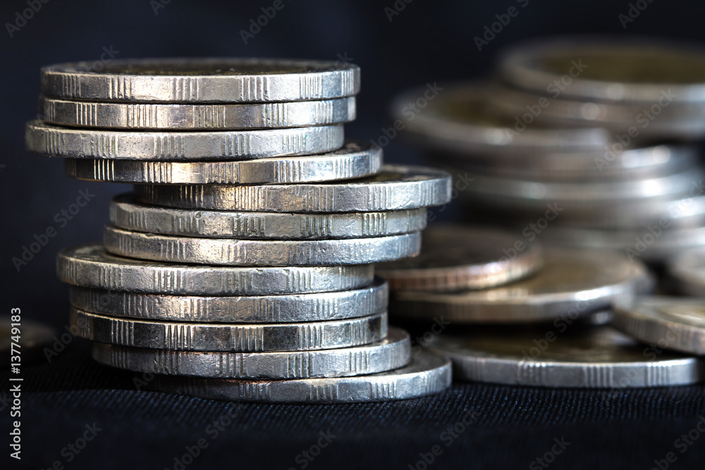 Close up silver money coin stacking on dark background Close up silver money coin stacking on dark background