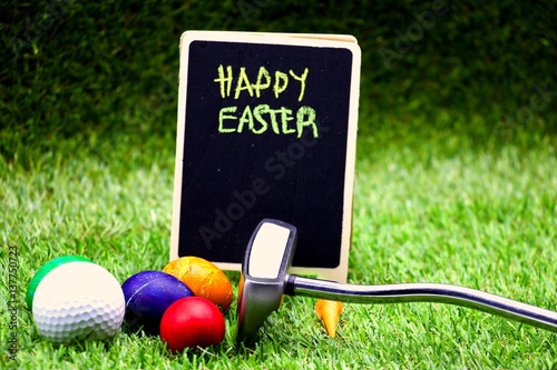 Obraz na płótnie Golf ball with Easter Eggs on green grass