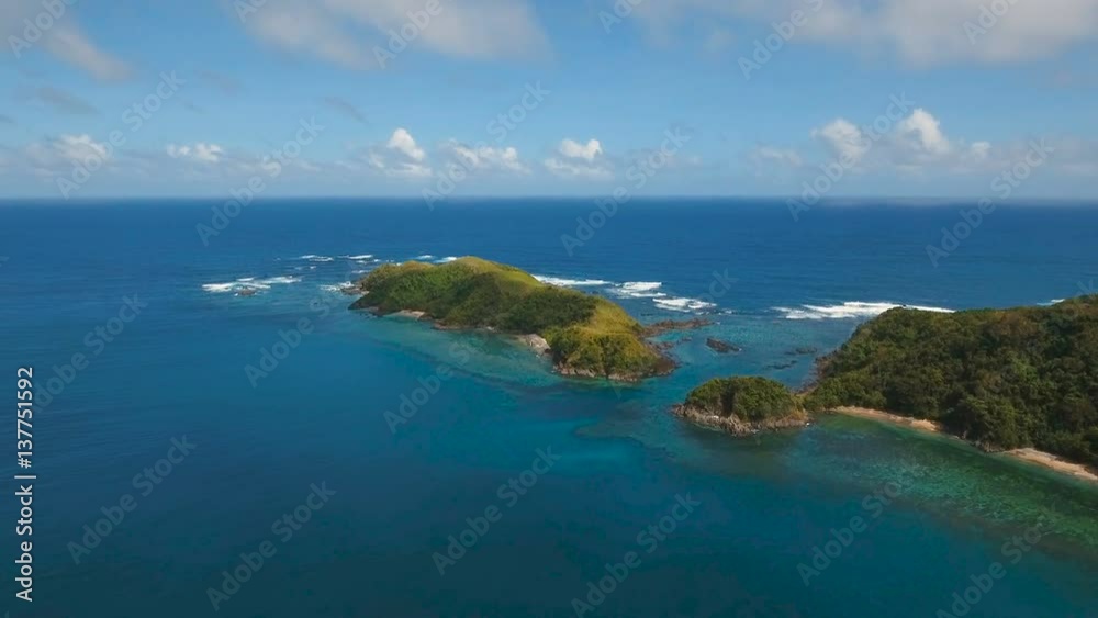 Aerial view:Tropical island with beach, mountains and the rainforest. Sea and the tropical island with rocks, beach and waves. Seascape: sky, clouds, rocks, ocean. 4K video. 4K video. Travel concept Aerial view:Tropical island with beach, mountains and the rainforest. Sea and the tropical island with rocks, beach and waves. Seascape: sky, clouds, rocks, ocean. 4K video. 4K video. Travel concept