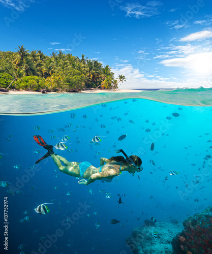 Young woman snorkeling on tropical beach