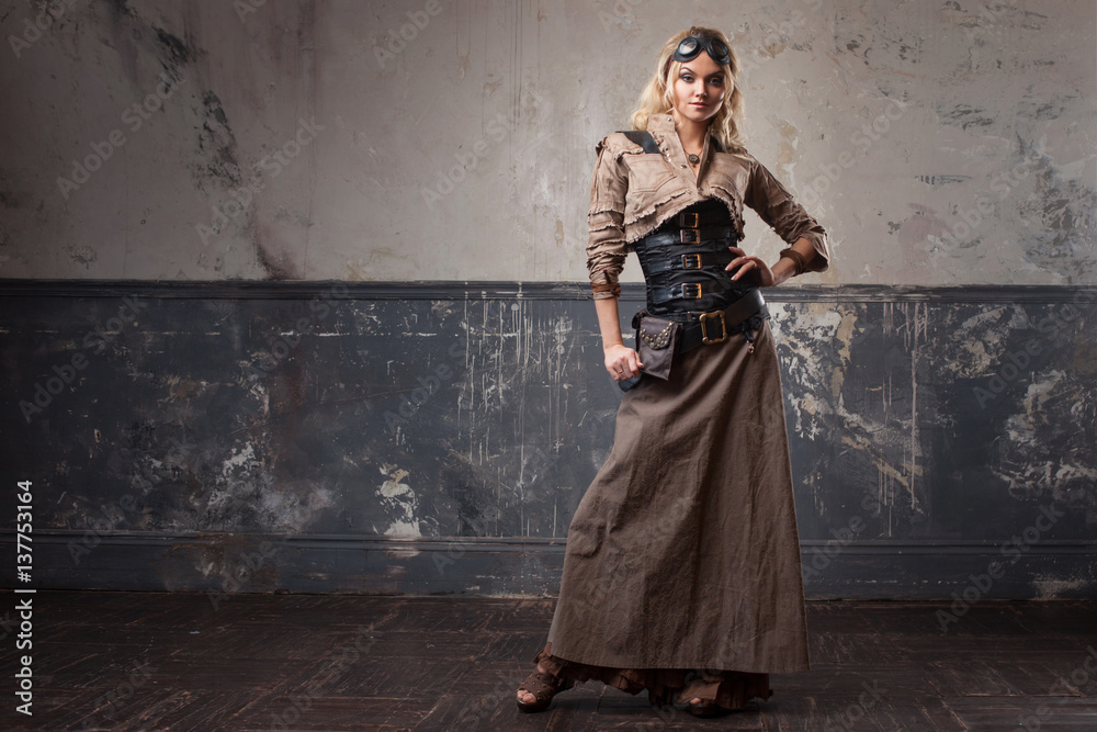 Portrait of a beautiful steampunk woman in Aviator glasses over grunge background. Portrait of a beautiful steampunk woman in Aviator glasses over grunge background.
