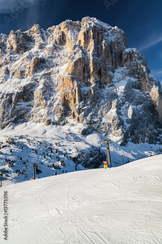 Sunny view of snowy valley near Canazei of Val di Fassa, Trentino-Alto-Adige region, Italy.