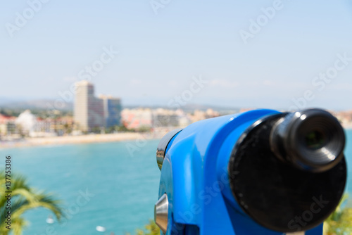 Blue Coin Operated Telescope Of Panoramic Tropical City And Ocean View