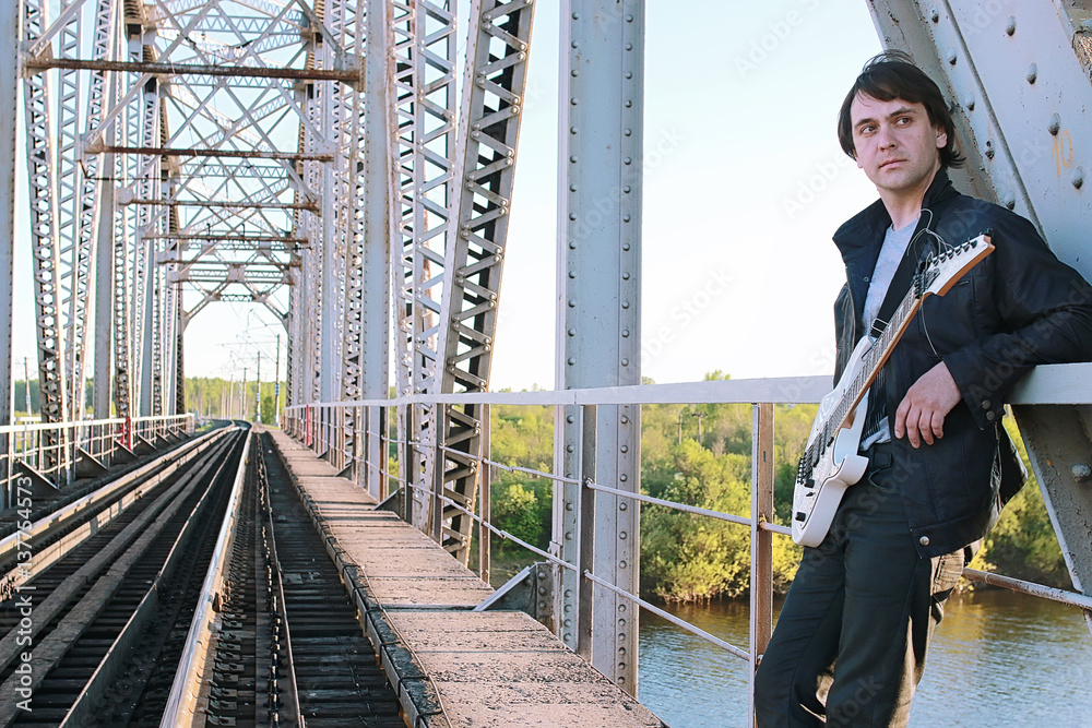 custom made wallpaper toronto digitalMan with an electric guitar in the industrial landscape outdoors