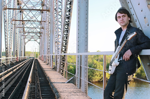 Wallpaper Mural Man with an electric guitar in the industrial landscape outdoors Torontodigital.ca