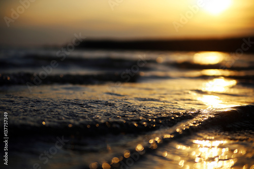 Sunset on the sea. The path from the sun on the waves in the ocean. The Golden sun reflection in the water on the lake at dawn. © evelinphoto