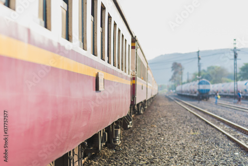 Passenger train of Thai Railways. The nearest purple car is in the focus, other things dissolve into nice bokeh. This is a second class sitting car of a train Ubon Ratchathani - Bangkok (Thailand)