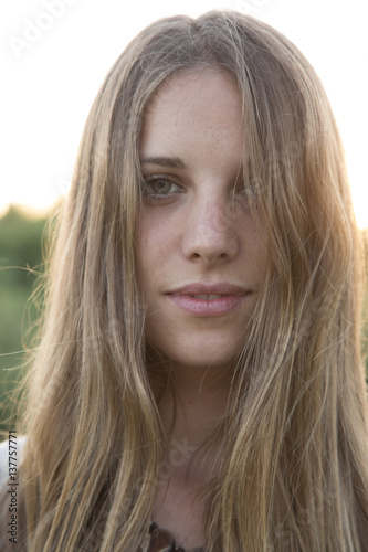 close up portrait of a beautiful young woman at sunset