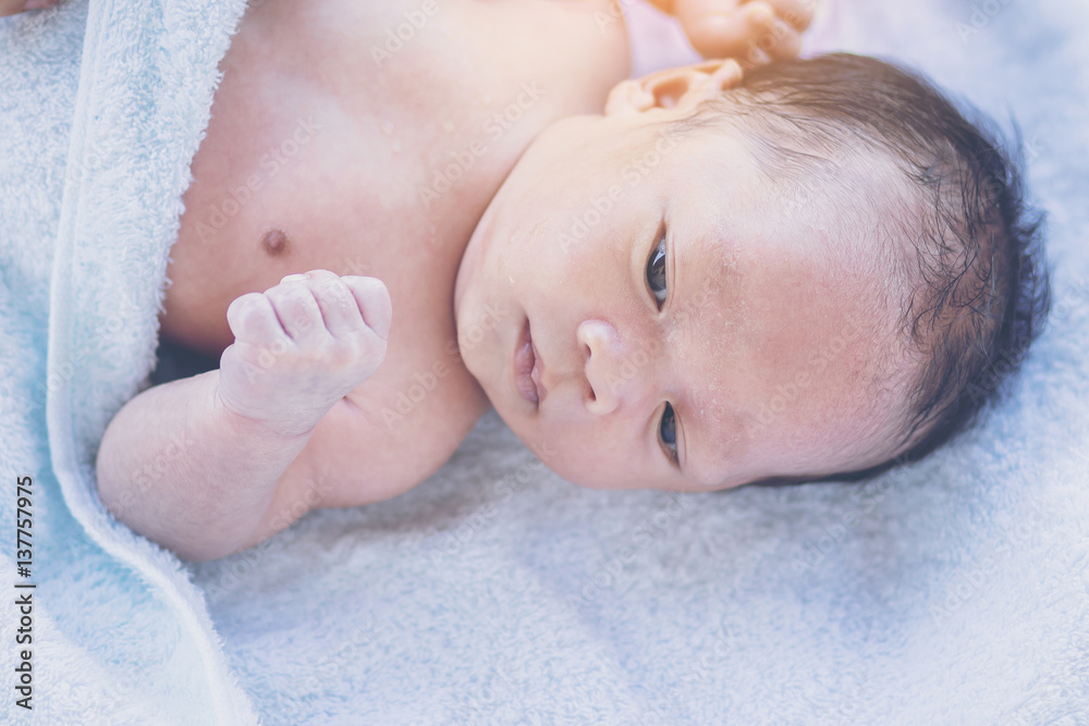 Cute baby lying on back in bathing towel Cute baby lying on back in bathing towel