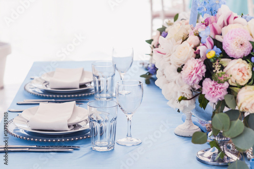 Beautiful decorated table set for wedding party. Wedding decorations with flowers