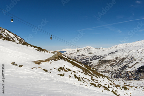 View of an alpine ski slope with cable car lift
