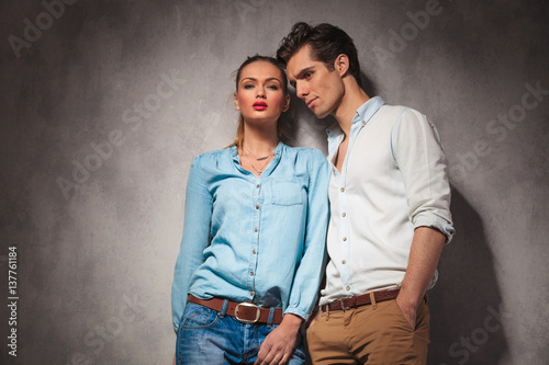 young casual couple standing close to each other
