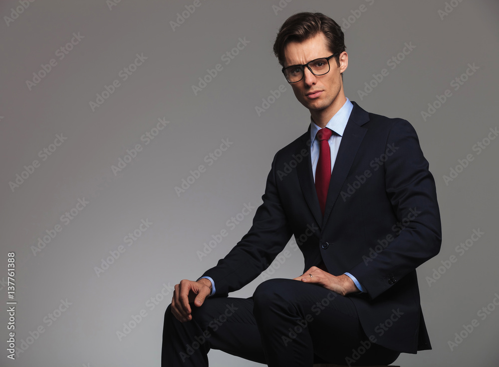 young seated businessman looks at the camera young seated businessman looks at the camera
