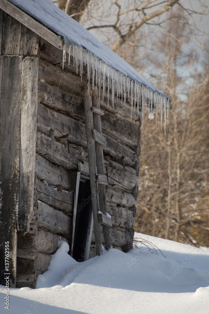 Snowy old log cabin barn with icicles Snowy old log cabin barn with icicles