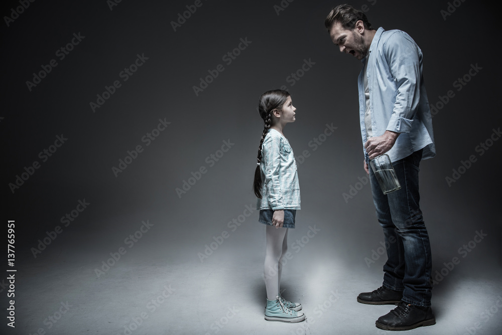 Fototapeta premium Angry man while shouting on his daughter
