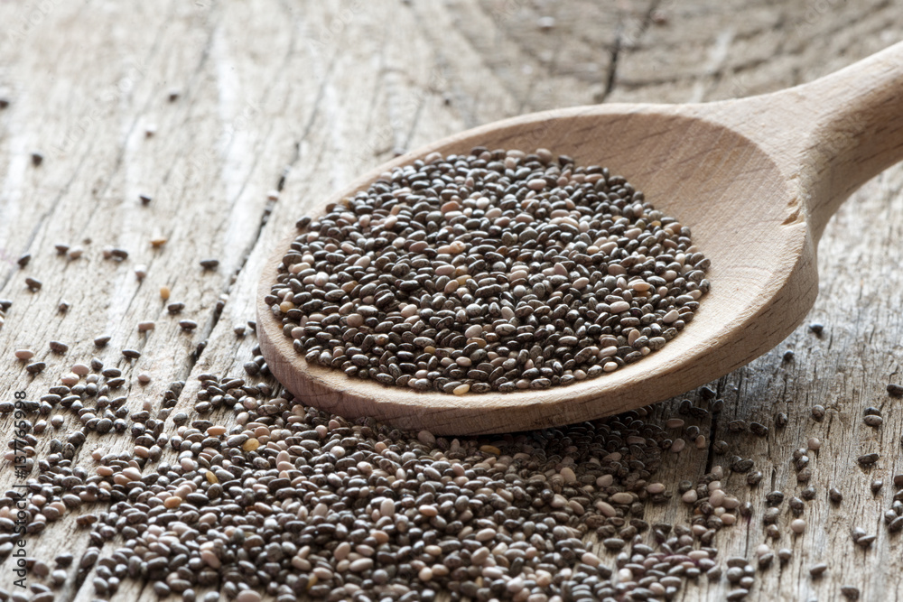 Chiaseeds on wooden spoon and wooden backround, superfood Chiaseeds on wooden spoon and wooden backround, superfood