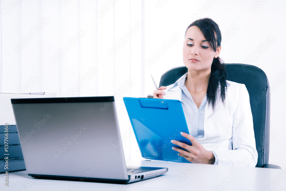 Young attractive business woman using laptop at the office Young attractive business woman using laptop at the office