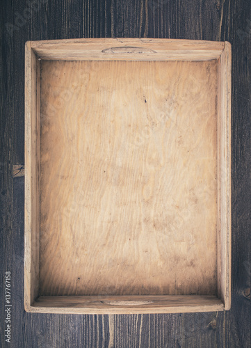 Empty rustic wooden box on table top view vertical. Toned