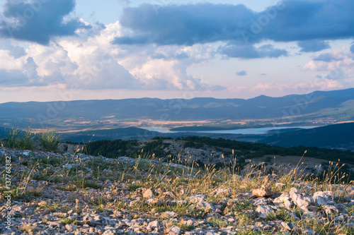 View of the valley Baydarskaya on the southern coast of Crimea. View from the top of the mountain Ilyas Kaya. Summer sunny and cloudy day. Enjoyable travel. Selective focus. photo